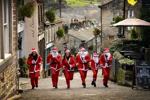 This group of ‘santas’ are pictures warming up on Main Street, Haworth.