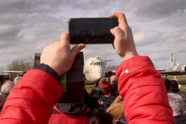 A visitor held up their phone to take a picture of the jet.
