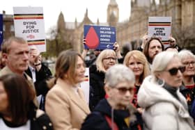 Infected blood victims and campaigners protest on College Green in Westminster. PIC: Aaron Chown/PA Wire