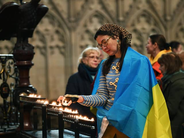 Lilia Zhukova lights a candle at the vigil held at York Minster, to mark the first anniversary of the invasion of Ukraine by Russian forces.
24th February 2023.