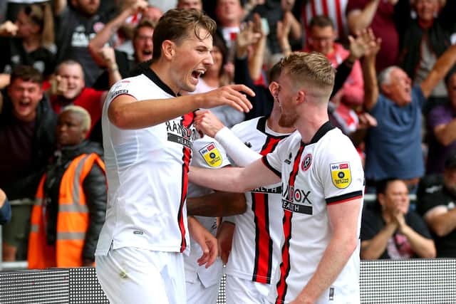 Sheffield United's Sander Berge (left) celebrates with his team-mates after scoring their side's second goal in the Yorkshire derby at Hull (Picture: Nigel French/PA Wire)