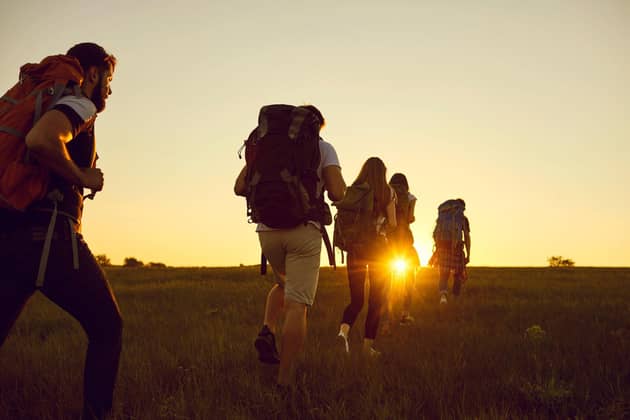 A group of friends hiking with heavy rucksacks. Picture: Alamy/P
