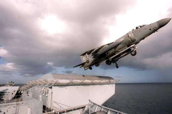 HMS Invincible launching a sea harrier fighter .