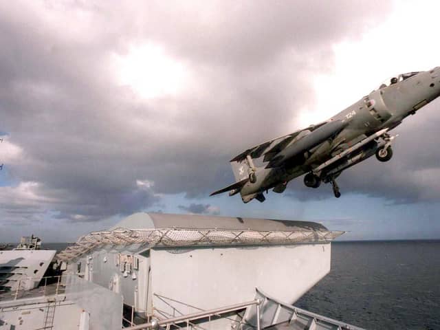HMS Invincible launching a sea harrier fighter .