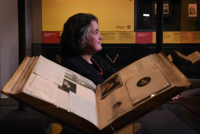 Literary Archivist and co-curator of the exhibition Sarah Prescott in front of printed portraits of Lord Byron.
