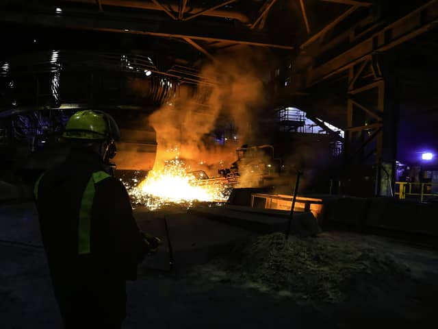 Archive pic - A steelworker watches as molten steel pours from one of the Blast Furnaces during 'tapping' at the British Steel - Scunthorpe plant in north Lincolnshire, north east England on September 29, 2016.