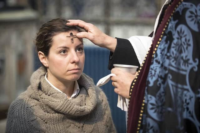 A worshiper receives the sign of the cross marked in ash on her forehead. (Pic credit: Danny Lawson / PA Wire)