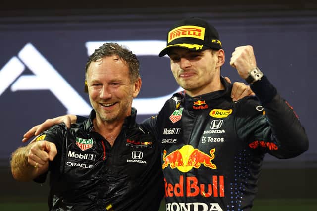 ABU DHABI, UNITED ARAB EMIRATES - DECEMBER 12: Race winner and 2021 F1 World Drivers Champion Max Verstappen of Netherlands and Red Bull Racing celebrates with Red Bull Racing Team Principal Christian Horner on the podium during the F1 Grand Prix of Abu Dhabi at Yas Marina Circuit on December 12, 2021 in Abu Dhabi, United Arab Emirates. (Photo by Bryn Lennon/Getty Images)