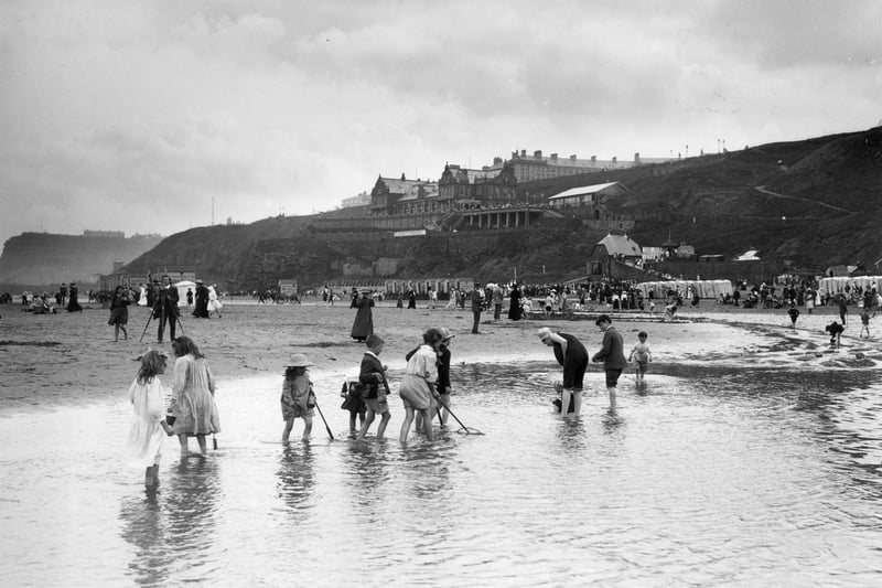Children paddling on the beach in Whitby circa 1913.