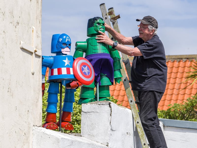 Tony Harwood positions his superheroes Captain America and The Hulk he has made for Flamborough Flowerpot Festival.