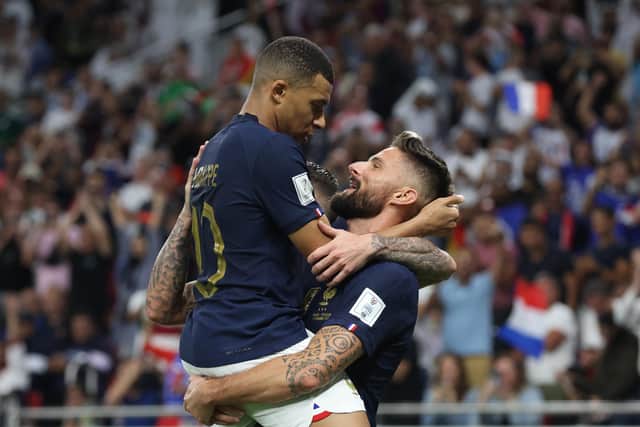 DOHA, QATAR - DECEMBER 04: Olivier Giroud of France celebrates with teammates Kylian Mbappe after scoring the team's first goal during the FIFA World Cup Qatar 2022 Round of 16 match between France and Poland at Al Thumama Stadium on December 04, 2022 in Doha, Qatar. (Photo by Alex Grimm/Getty Images)