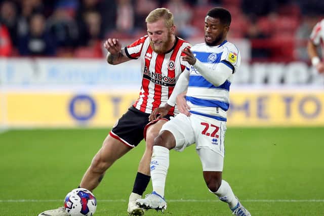 Sheffield United's Oliver McBurnie (left) and Queens Park Rangers' Kenneth Paal battle for the ball during the Sky Bet Championship match at Bramall Lane. Picture: PA/Nigel French.