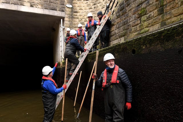 Workers and volunteers get to work to clean up Tuel Lane Lock at Sowerby Bridge, from leaves and debris.