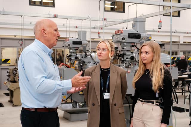 HETA business development executive Mick Wigglesworth with Holly Barker (centre) and Zoe Pell of EFAB in the mechanical engineering workshop.(Photo supplied by HETA)