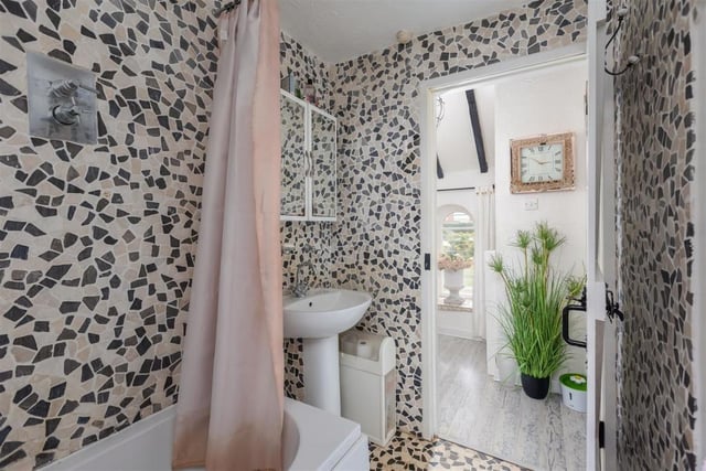 In keeping with the decor in the rest of the cotage, the bathroom is stylish