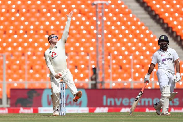 Dom Bess in action on his last Test appearance against India in Ahmedabad in 2021. Rishabh Pant is the non-striker. Photo by Surjeet Yadav/Getty Images.