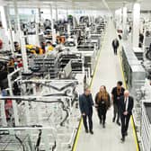 Prime Minister Sir Keir Starmer with (left to right) two apprentices and Work and Pensions Secretary Pat McFadden during a visit to McLaren Automotive last year. PIC: Jonathan Brady/PA Wire