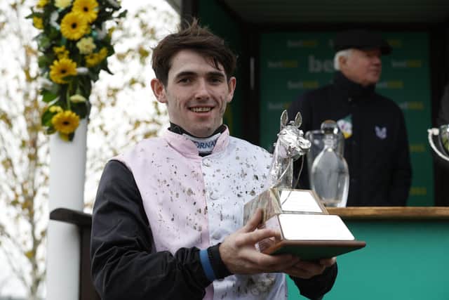 Prize performance: Jockey Darragh O'Keeffe with his trophy for winning the bet365 Charlie Hall Chase. Picture: Nigel French/PA Wire.