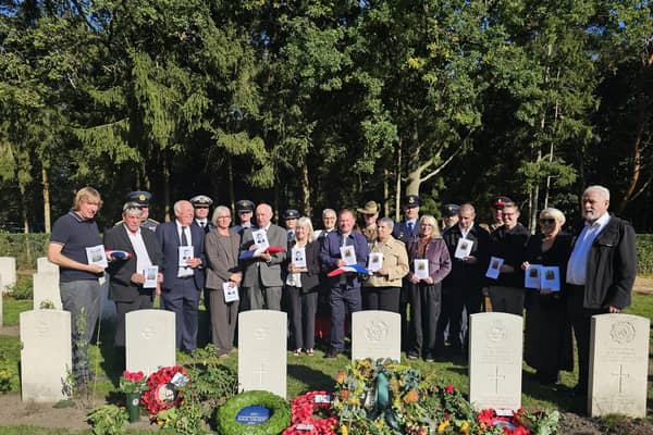 Family and military representatives at the  graves of Sheffield RAF hero John Tales and four others who died after the same bomber crashed. Photo: MOD