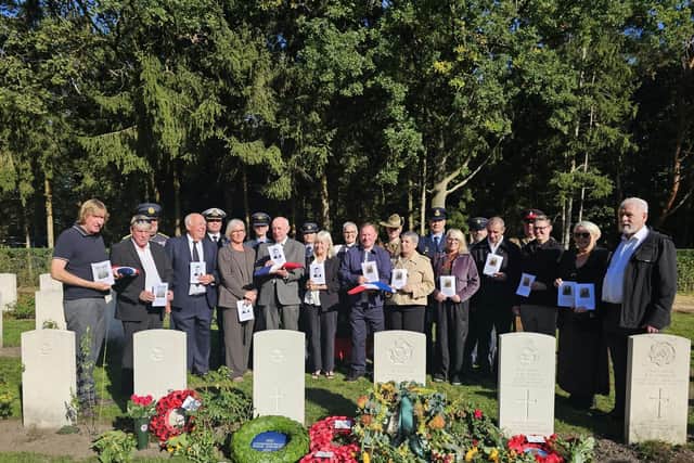 Family and military representatives at the graves of Sheffield RAF hero John Tales and four others who died after the same bomber crashed. Photo: MOD