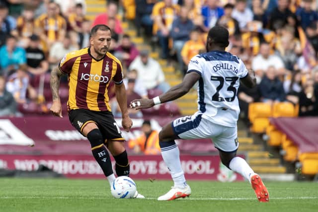Bradford City's Antoni Sarcevic is closed by Mansfield's Deji Oshilaja in League One on Saturday. (Picture: Tony Johnson)
