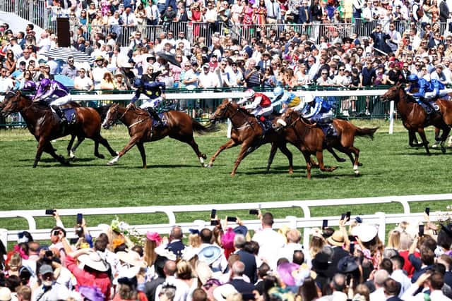 Jockey Oisin Murphy drives Shaquille (2L) past Ryan Moore on Little Big Bear (L) to win the Commonwealth Cup on the fourth day of the Royal Ascot horse racing meeting (Picture: HENRY NICHOLLS/AFP via Getty Images)