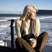 Emily wears a striped cashmere jumper on location in Saltburn. “It was a freezing cold day,” says Ali.