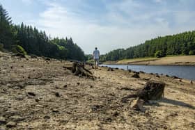 The submerged walls of buildings and boundary walls as well as the stumps of felled trees emerge from the low water levels at Thruscross Reservoir near Harrogate as the long spell without significant rainfall continued this summer