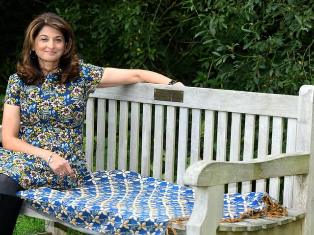 Daxa Patel sat on her father's memorial bench in Golden Acre park in Leeds. PIC: Gary Longbottom