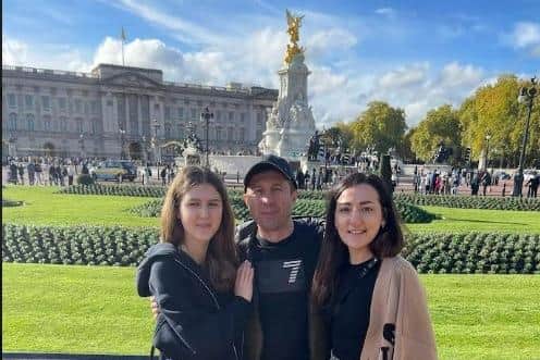 Olga Fedchenko (right) with husband Sergiy and daughter Polina on a trip to Buckingham Palace in London.