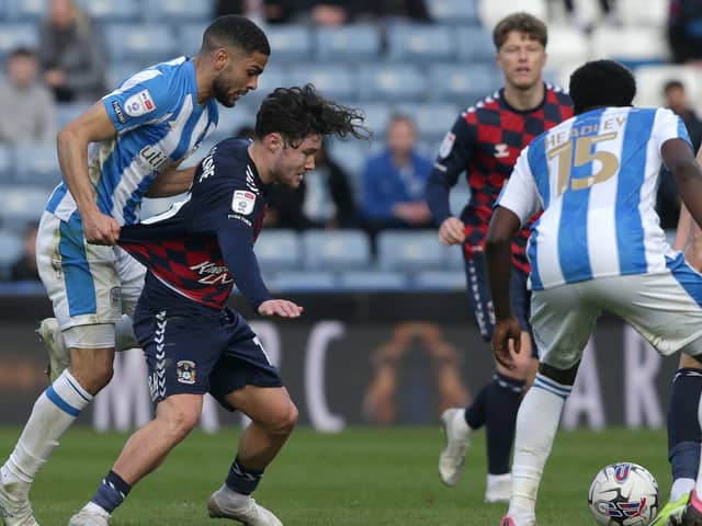 Huddersfield Town's Brodie Spencer (left) and Coventry City's Callum O'Hare battle for the ball during the Sky Bet Championship match at the John Smith's Stadium, Huddersfield. Picture date: Friday March 29, 2024. PA Photo. See PA story SOCCER Huddersfield. Photo credit should read: Ian Hodgson/PA Wire.

RESTRICTIONS: EDITORIAL USE ONLY No use with unauthorised audio, video, data, fixture lists, club/league logos or "live" services. Online in-match use limited to 120 images, no video emulation. No use in betting, games or single club/league/player publications.