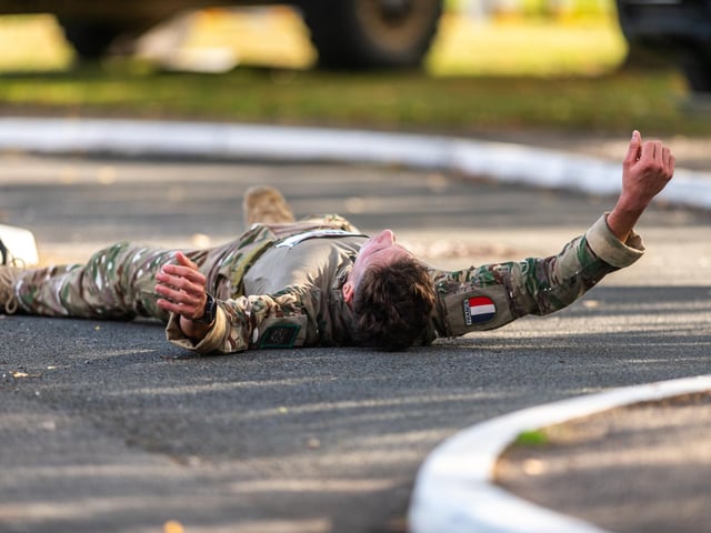 French soldier Mahe Pol, aged 22, from the The 27e bataillon de chasseurs alpins battalion of the French Army totally exhausted after crossing the finishing line in first place.