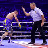 SHEFFIELD, ENGLAND - OCTOBER 07: Referee goes for the countdown after Josh Warrington gets knocked out by Leigh Wood  during the WBA World Featherweight Title fight between Leigh Wood and Josh Warrington at Utilita Arena Sheffield on October 07, 2023 in Sheffield, England. (Photo by James Chance/Getty Images)