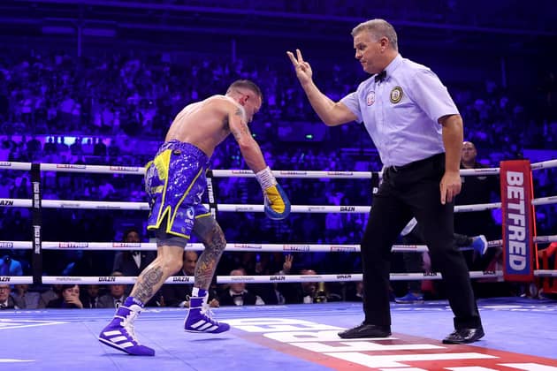 SHEFFIELD, ENGLAND - OCTOBER 07: Referee goes for the countdown after Josh Warrington gets knocked out by Leigh Wood  during the WBA World Featherweight Title fight between Leigh Wood and Josh Warrington at Utilita Arena Sheffield on October 07, 2023 in Sheffield, England. (Photo by James Chance/Getty Images)