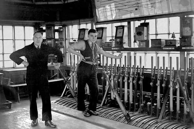 The interior of Leeds Marsh Lane signal box with the Signalman and Train Recorder posing for the Yorkshire Post photographer in November 1951