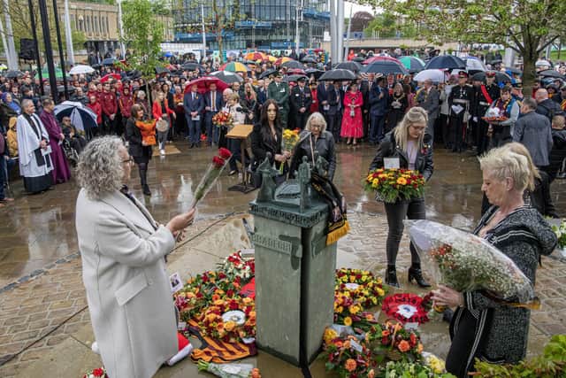 REMEMBERING: Relatives and fans lay flowers at the memorial service to remember the 56 people who died in the Bradford Fire disaster in 1985 at the Memorial sculpture in the city's Centenary Square