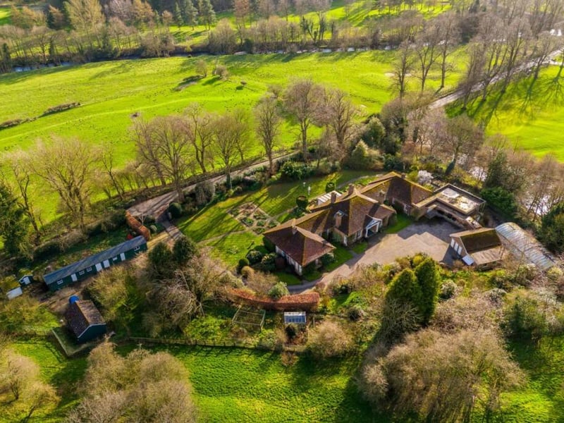 A shot from above of the substantial eight bedroom property that sits in a sublime location on the edge of Masham