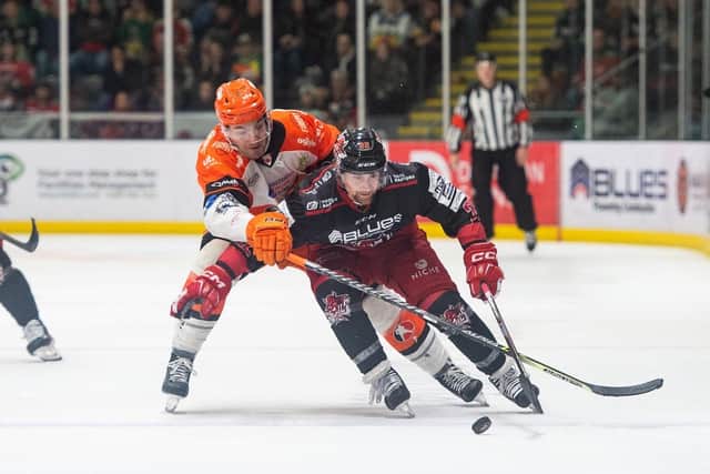 CLOSE RUN BATTLE: Sheffield Steelers' Mason Mitchell (left) battles with Cardiff Devils' Justin Crandall at Ice Arena Wales. Picture courtesy of James Assinder/EIHL Media.