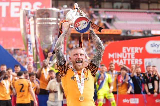 Hull City's Oliver McBurnie celebrates with the trophy after winning promotion to the Premier League following the Sky Bet Championship play-off final against Middlesbrough at Wembley Stadium, London. Picture: Adam Davy/PA Wire.
