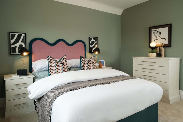 One of the bedrooms with a restful colour pallette livened by the pink headboard