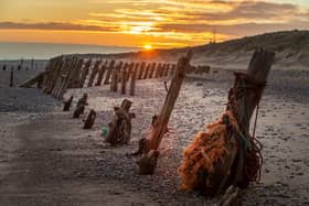 Some of the old wooden pillings at sunset on the beach at Spurn Point. PIC: Bruce Rollinson