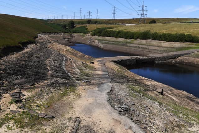 Low water levels at Baitings Reservoir, near Ripponden, revealing the old packhorse bridge.