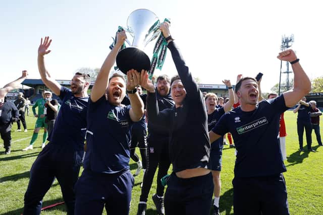 Maynard (second right) celebrates with his staff and the trophy after his team won the National League at Rochdale in dramatic circumstances in late April. Picture: Cody Froggatt/PA
