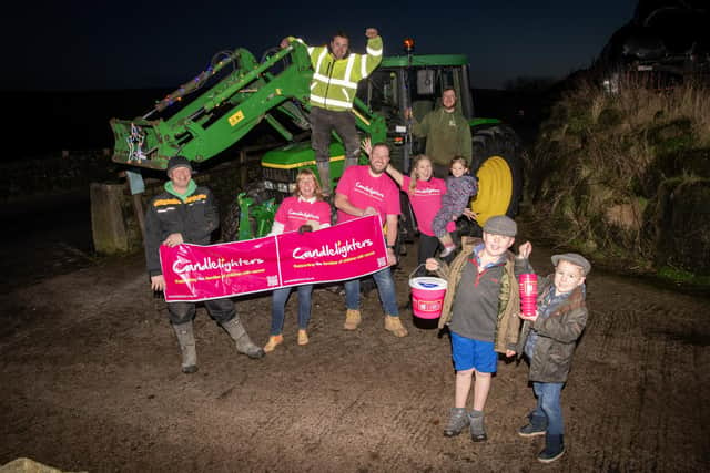 Julia Taylor from CN Trading Ltd, James Lively, Tom Newsome, Meg Whitaker Gault with Emma 5, Tomas Mills and brothers Ernie and Stan Newsome ready to raise money for Candlelighters with the Christmas Eve Tractor Run around Hebden Bridge