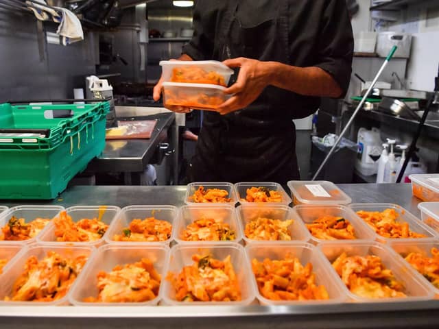 Kitchen staff at a pub preparing free packed lunches. PIC: Ben Birchall/PA Wire
