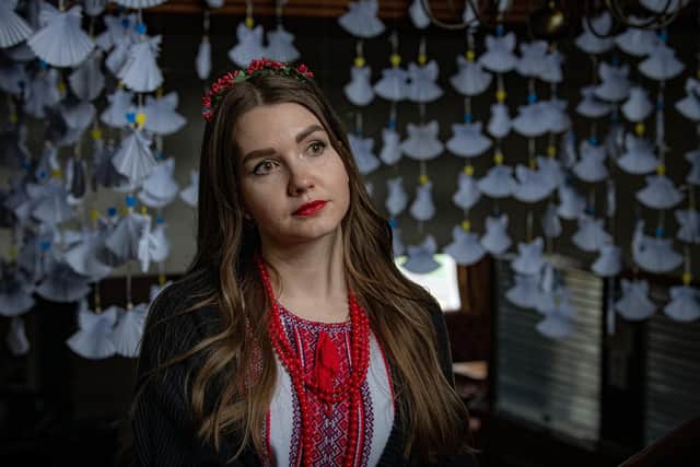 Ukrainian refugee Viktoriia Prysiazhna who fled Odesa marks the second anniversary of the war with Russia among paper angels at the Ukrainian Community Centre in Bradford representing the children killed during the conflict. Photographed for The Yorkshire Post by Tony Johnson.