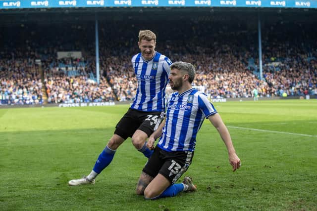 Relief: Sheffield Wednesday’s Callum Paterson, right, is joined by Michael Smith after redirecting Marvin Johnson's wayward shot goalbound to give the Owls the lead against Exeter City.