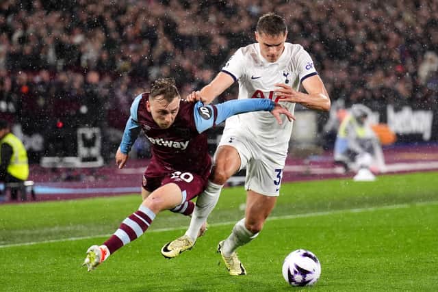 THIS IS NOW: West Ham United's Jarrod Bowen (left) and Tottenham Hotspur's Micky van de Ven battle for the ball at the London Stadium on Tuesday night. Picture: John Walton/PA