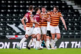 Bradford City's Sam Stubbs (centre right) celebrates with his team-mates after scoring their side's first goal of the game during the Bristol City Motors Trophy round of 16 match at Pride Park (Picture: PA)