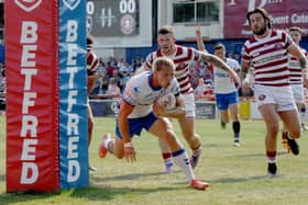 ON THE MOVE: Jacob Miller scores a try for Wakefield Trinity against Wigan in August. He has signed a three-year deal with arch-rivals Castleford Tigers. Picture: Steve Riding.